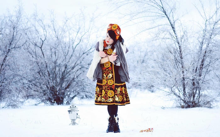 Woman in traditional Russian clothing in a snowy landscape