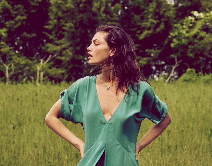 Phoebe Tonkin in a green dress outdoors