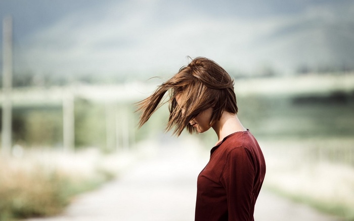 Woman with windblown hair on a road