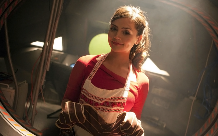 Jenna Coleman in a red top and apron