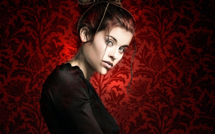 Woman with dark hair against red floral pattern