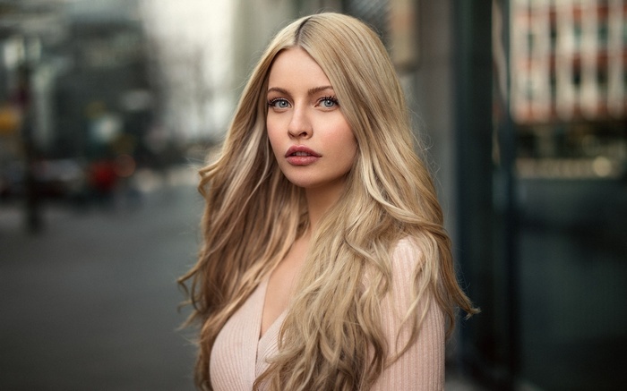 Woman with blonde hair in a pink top