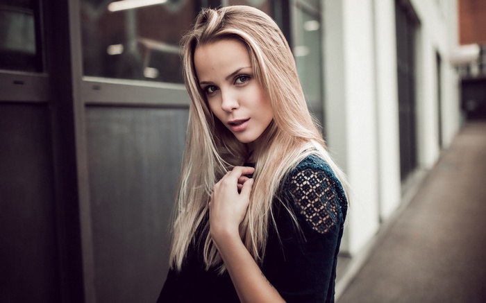 Woman with blonde hair posing outdoors