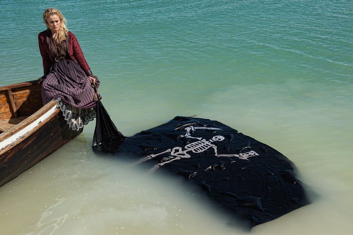 Hannah New in a boat with a pirate flag