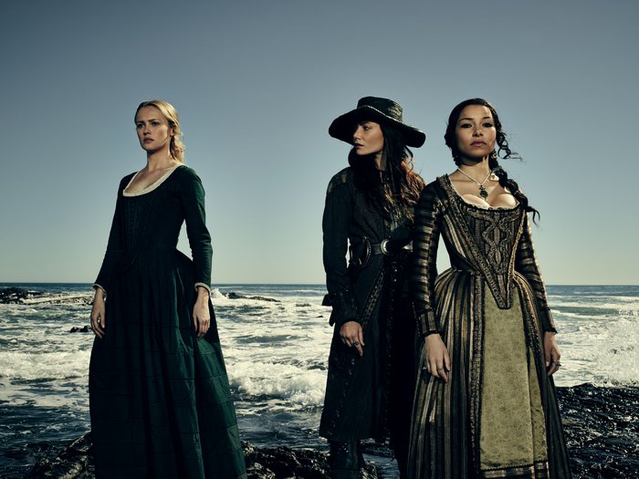 Hannah New and two women on a rocky shore