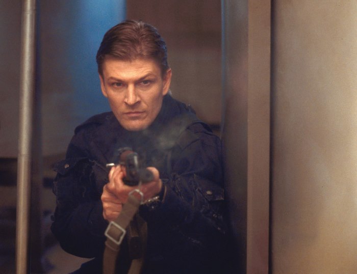 Sean Bean aiming a rifle