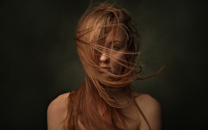 Woman with red hair blowing in the wind