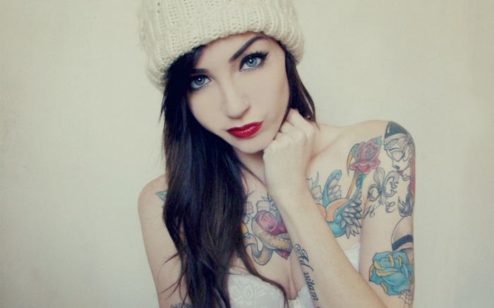 Woman with tattoos wearing a beanie