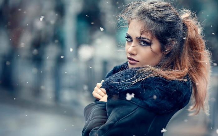 Woman in a fur-lined coat in the snow
