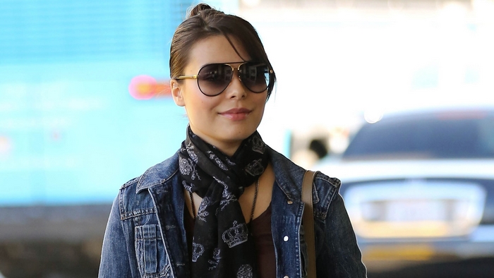 Miranda Cosgrove wearing sunglasses and denim jacket