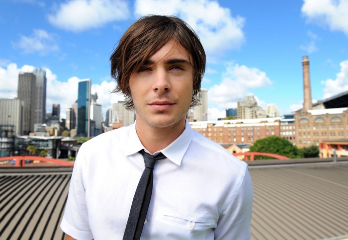 Zac Efron in front of city skyline
