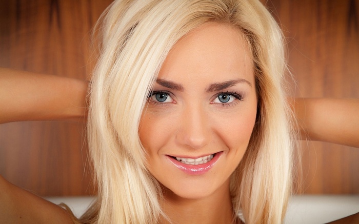 Blonde woman with blue eyes smiling