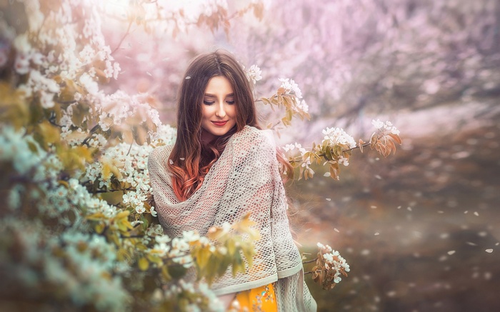 Woman in a shawl surrounded by blooming trees