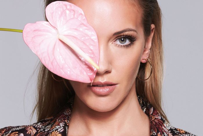 Katie Cassidy with pink Anthurium flower