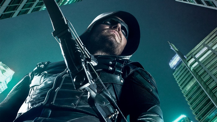 Stephen Amell as Green Arrow in a city at night