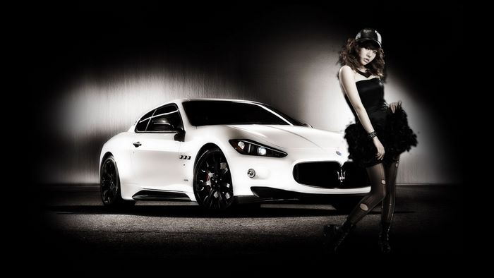Woman posing with a white Maserati GranTurismo