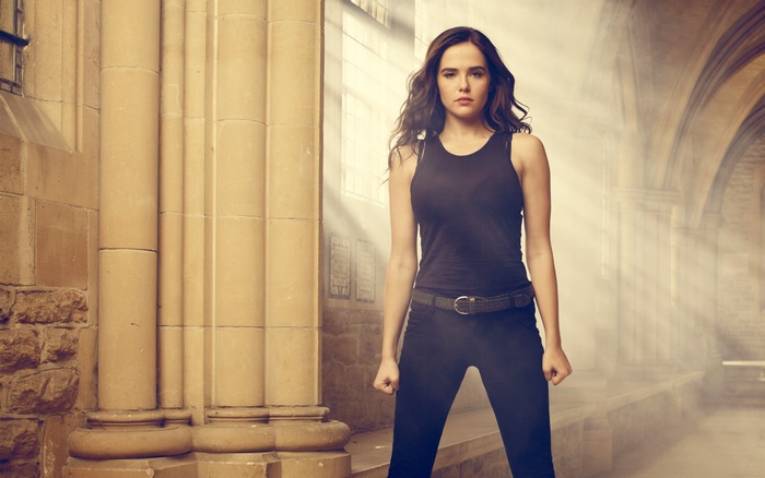 Zoey Deutch in a black tank top and jeans