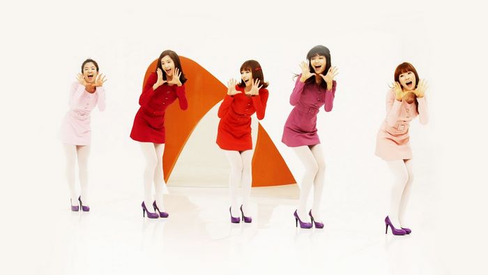 Girls Generation members in colorful dresses