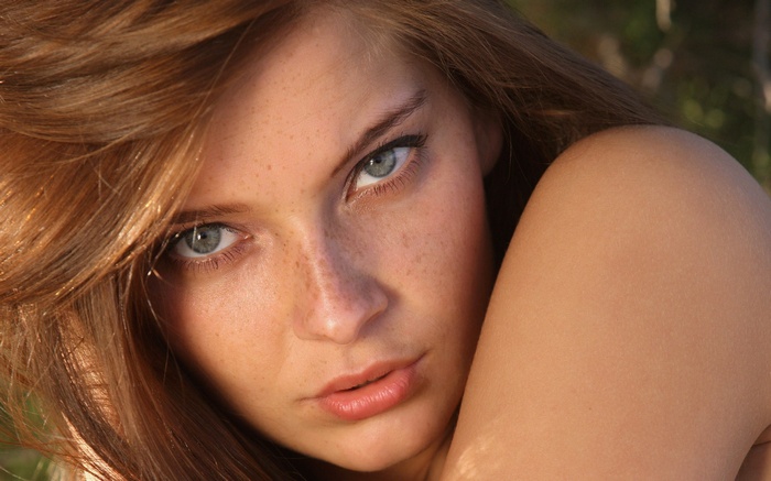 Close-up of a young woman with freckles