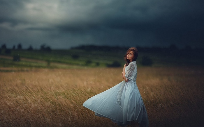 Woman in a flowing dress in a field