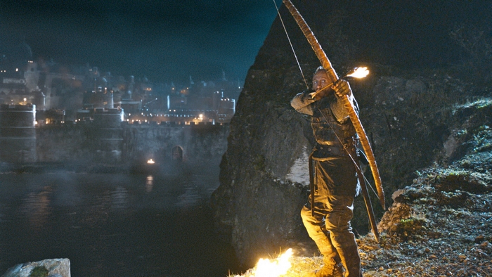 Bronn from Game of Thrones with a bow and arrow