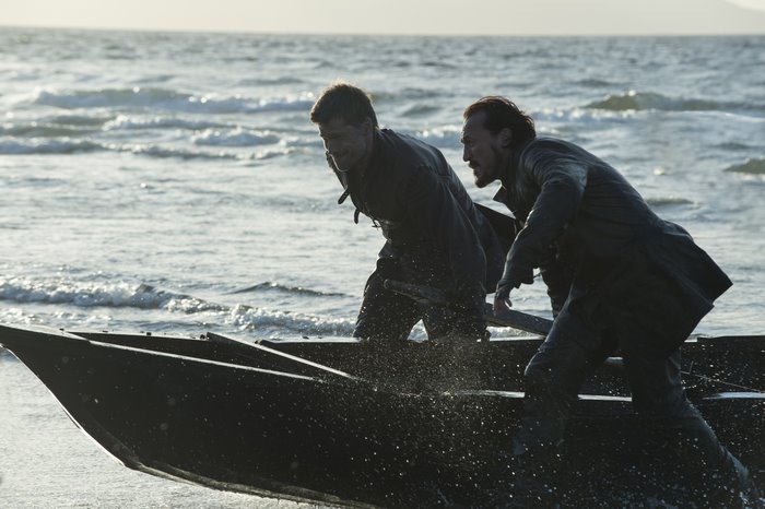 Two men in a boat on the water
