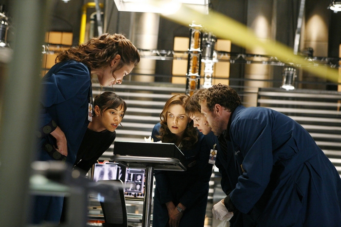 Michaela Conlin and colleagues examining a screen