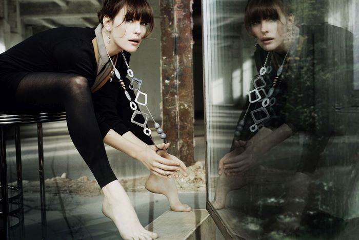 Liv Tyler sitting on a stool
