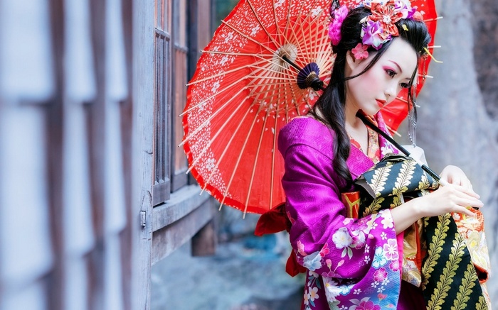 Geisha with red umbrella and kimono