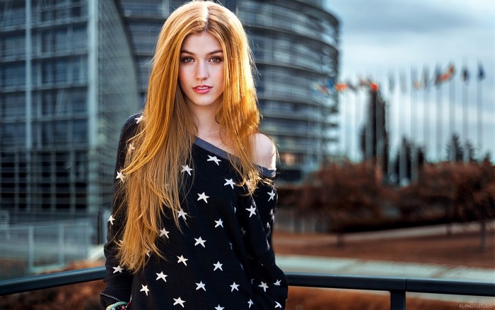 Katherine McNamara in front of modern architecture