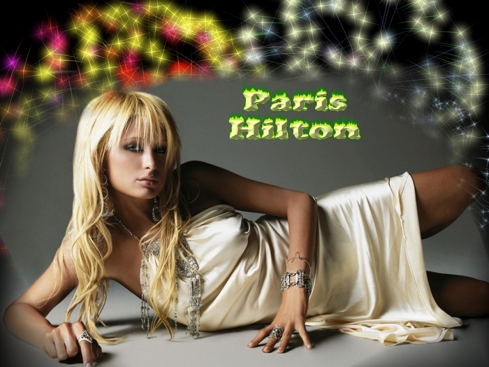Paris Hilton posing in a satin dress with sparkling lights
