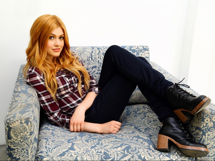 Katherine McNamara sitting on a couch