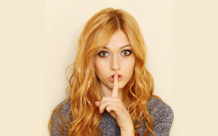 Katherine McNamara with finger on lips