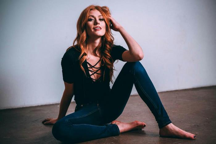 Katherine McNamara sitting on floor