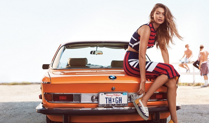 Gigi Hadid sitting on a vintage BMW