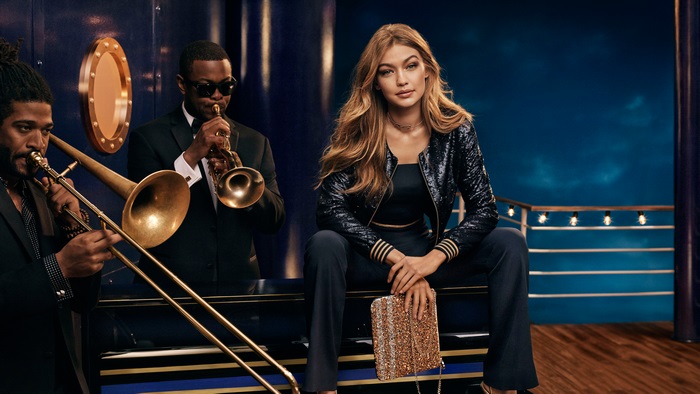 Gigi Hadid with musicians on a ship deck
