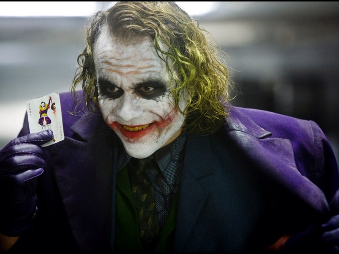 The Joker from The Dark Knight holding a card
