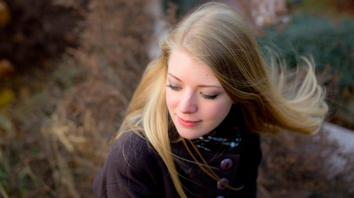 Young woman with blonde hair wearing a coat