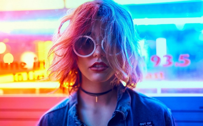 Woman with pink and blue hair wearing sunglasses