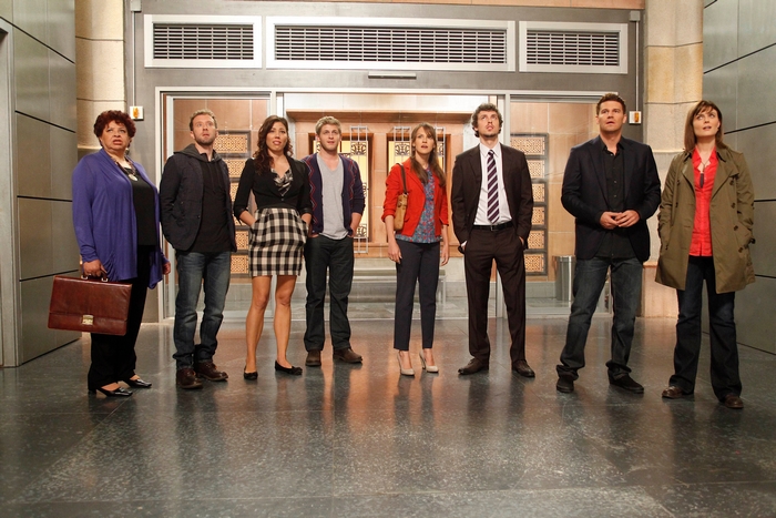 T. J. Thyne and cast standing in a hallway
