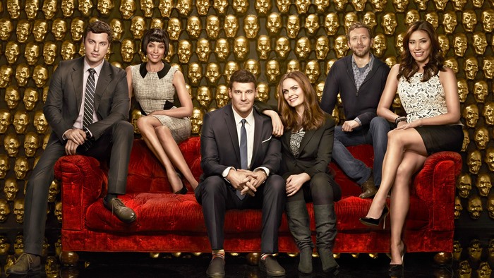 Bones cast sitting on a red couch