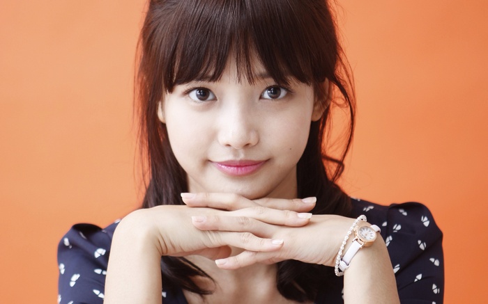 Young woman with dark hair and bangs