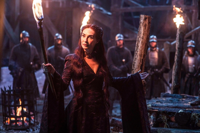 Melisandre from Game of Thrones holding a torch