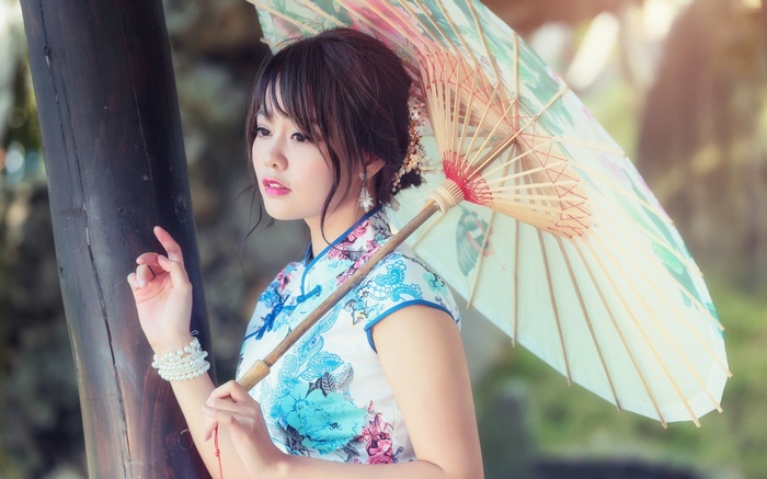Woman in Cheongsam holding a parasol