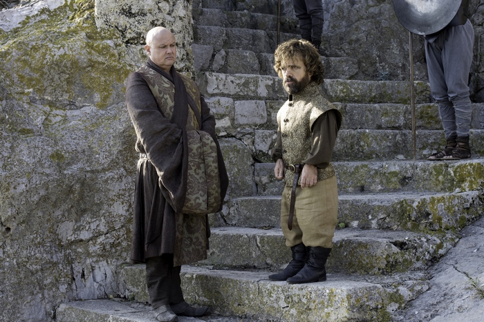 Lord Varys and Tyrion Lannister on stone steps