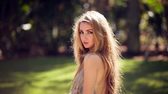 Woman with long blonde hair in a park