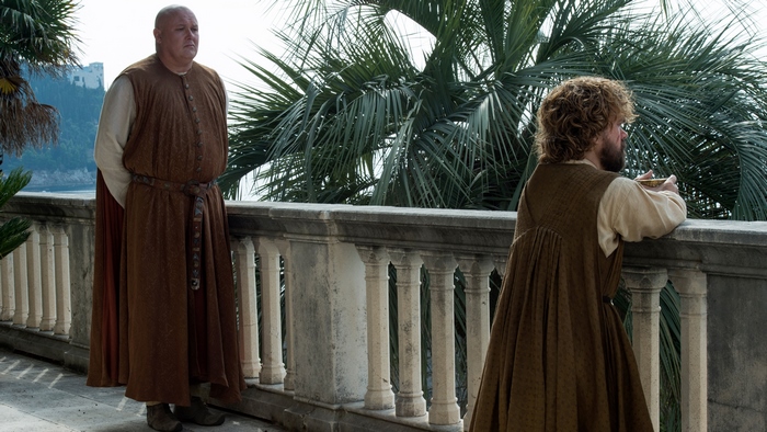 Lord Varys and Tyrion Lannister on a balcony