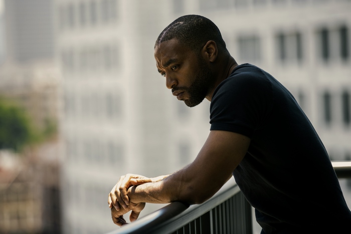 Anthony Mackie on a balcony
