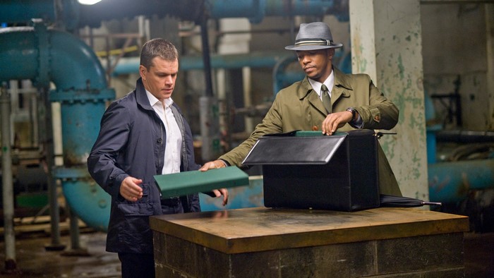 Matt Damon and Anthony Mackie in a dark room