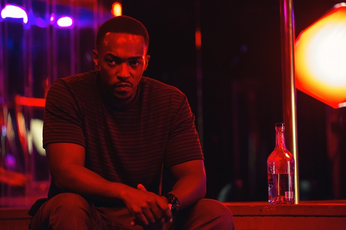Anthony Mackie in a dimly lit room